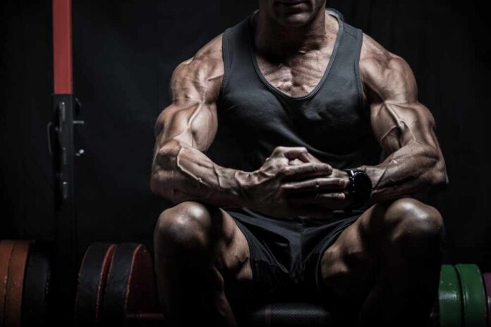 Very,Muscular,Bodybuilder,Man,With,Veins,On,The,Body,Sitting