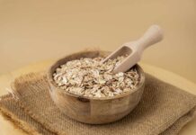 Gut Bacteria Revelation: Oats’ Hidden Power A wooden bowl filled with oats and a wooden scoop