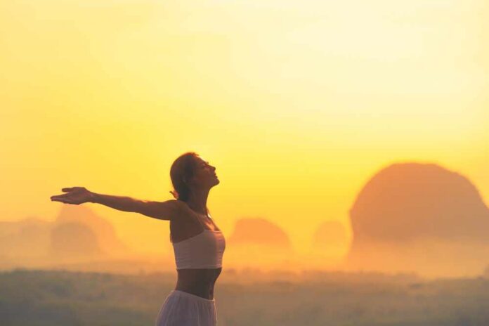 Silhouette,Of,A,Woman,In,White,Outfit,Standing,With,Arms