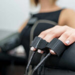 Close-up of a patients hand during a medical examination with monitoring equipment