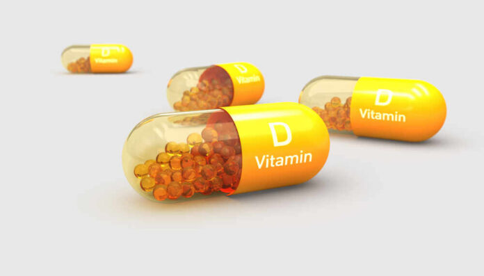shutterstock_1735208579.jpg Vitamin D capsules with orange beads inside