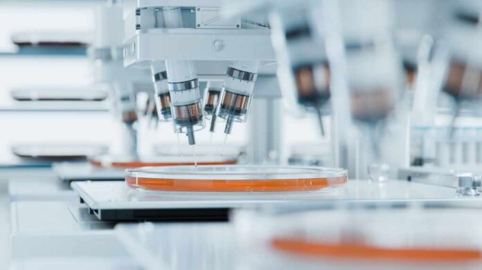 Automated laboratory equipment with robotic arms dispensing liquids into petri dishes