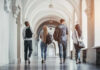 Group of students walking together in a university hallway