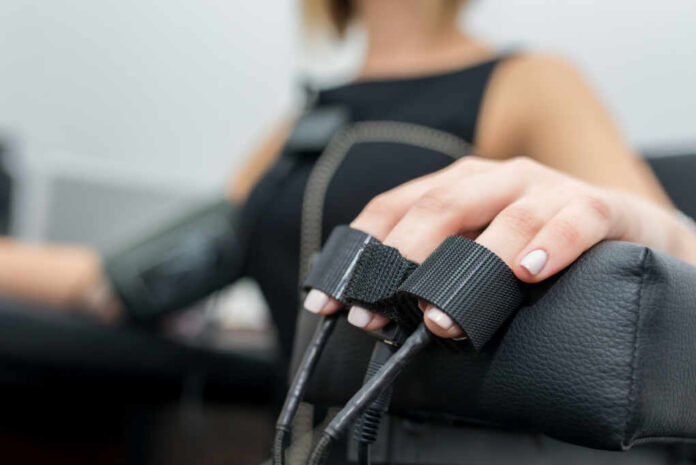 Close-up of a patients hand during a medical examination with monitoring equipment
