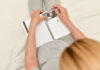 Pregnant woman writing in a journal while holding an ultrasound photo