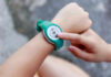 Can Exercise Actually Make You Happier Instantly? Person using a fitness tracker on their wrist