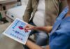 Hidden Forces Behind U.S. Mortality Rise Nurse showing a patient health data on a tablet