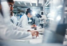 Scientists Find Gut Particles Aging Us Faster! Scientists working in a laboratory with microscopes and test tubes