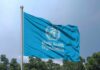 Global Health SHOCKER: TB Goals Abandoned! Flag of the World Health Organization waving against a blue sky