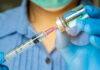 Controversial ‘Vaccine’ Targets Fentanyl Highs Healthcare professional preparing a syringe from a vial