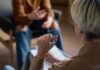 Two individuals engaged in a conversation during a counseling session