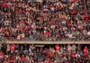 Crowd of fans filling stadium seats