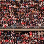 Crowd of fans filling stadium seats