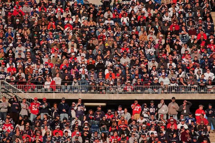 Crowd of fans filling stadium seats