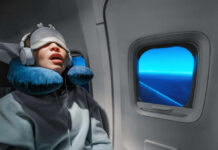 Ignored Snoring—Parkinson’s Risk DOUBLED? A passenger sleeping on an airplane with headphones and an eye mask