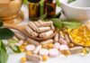 How to Tell If a Wellness Product Actually Works Various herbal supplements and vitamins arranged with leaves and a mortar