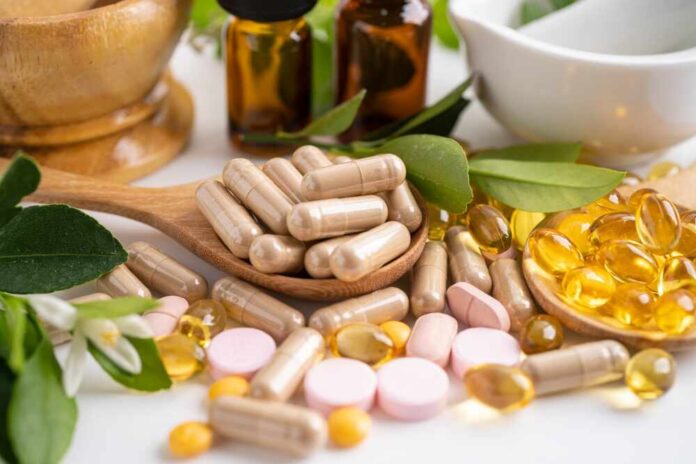 Alternative,Medicine,Herbal,Organic,Capsule,With,Vitamin,E,Omega,3 Various herbal supplements and vitamins arranged with leaves and a mortar