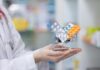 Popular Diabetes–Heartburn Duo Quietly Wrecks Nerves A doctor holding a miniature shopping cart filled with various medication packs