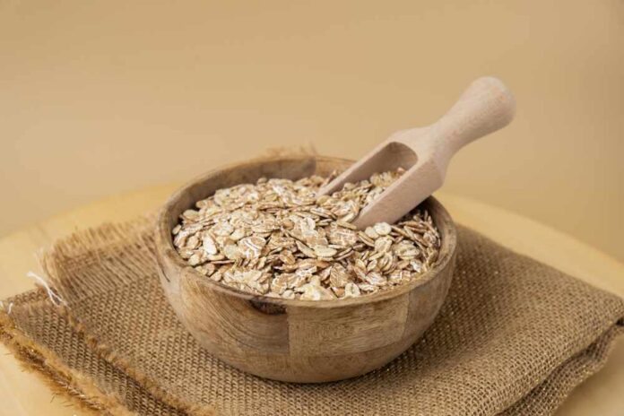 Raw,Oatmeal,Porridge,Gluten,Free,Cereals.,Health,Gut,Benefits.,Concept A wooden bowl filled with oats and a wooden scoop