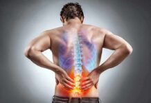 Man holding lower back with highlighted spine illustration