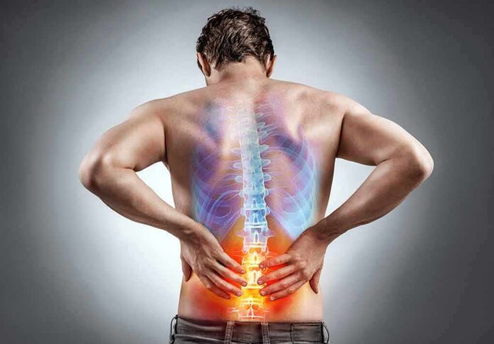 Man holding lower back with highlighted spine illustration