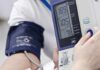Silent Deficiency Driving America’s Pressure Crisis Person having blood pressure measured with digital monitor