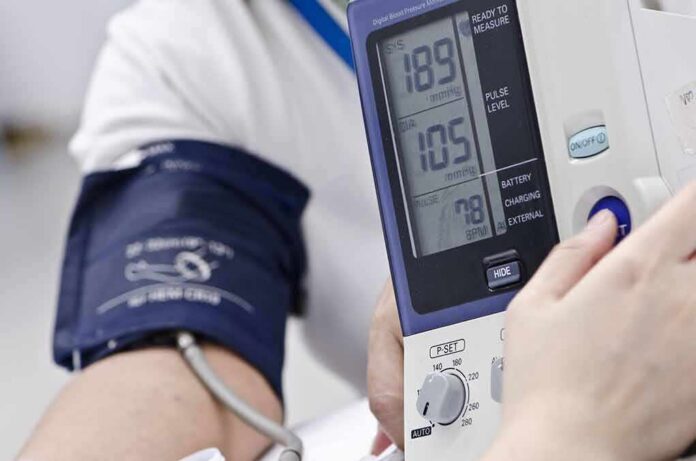 Person having blood pressure measured with digital monitor