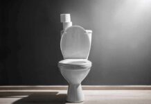 Why You Should NEVER Scroll while on the Toilet White toilet with open lid against gray wall