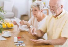 Doctor Favorite BP Pill Linked To Kidney Collapse Older man taking pills at a table while woman reads instructions