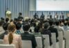 Audience listening to a panel discussion in a conference hall