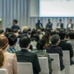 Audience listening to a panel discussion in a conference hall