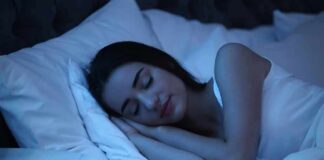 Woman sleeping on her side in bed