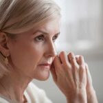 Woman with short blonde hair in thoughtful pose