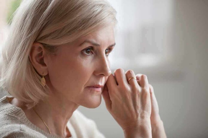 shutterstock_1185179218 Woman with short blonde hair in thoughtful pose