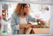 Food Anxiety Tied To Hidden Depression Spike Woman unpacking groceries into a refrigerator