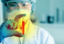 Cancer Breath Test Stuns Oncologists Scientist holding a test tube with red liquid