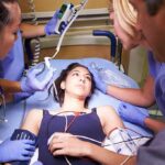 Patient on hospital gurney surrounded by medical staff