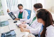 Doctors reviewing chest X-ray at a workstation