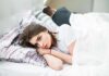How to Stop Marriage Drift Woman lying awake in bed next to partner turned away