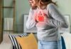 How Fitness Can Hide Heart Attack Danger Woman holding her chest in discomfort with a heart illustration