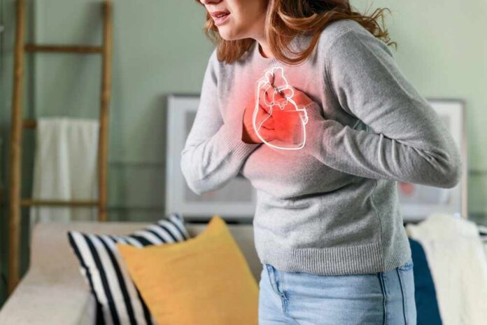 Young,Woman,Pressing,On,Chest,With,Painful,Expression.,Severe,Heartache, Woman holding her chest in discomfort with a heart illustration