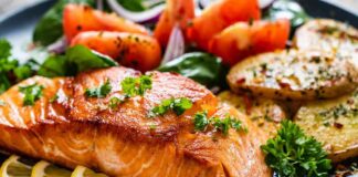 Seared salmon fillet with lemon slices and vegetables