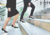 The Death Clock In Your Walk Two businesspeople in formal wear walking up stairs