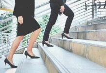 The Death Clock In Your Walk Two businesspeople in formal wear walking up stairs