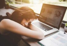 Afternoon Power Nap—Or Waist Trap? Woman resting her head on desk beside an open laptop