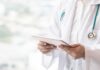 5 Midlife Health Checkups, Decade-Long Payoff Doctor with stethoscope using a tablet