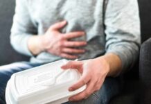 Frequent Bowel Movements: Causes & Treatment Person holding stomach with takeout container on lap