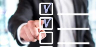 person in suit pointing at a digital checklist
