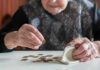 Financial problems and brain aging explained Elderly person counting coins on a table