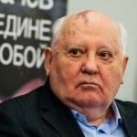 Man with bald head and birthmark looks to the side, identified as Mikhail Tumanishvili